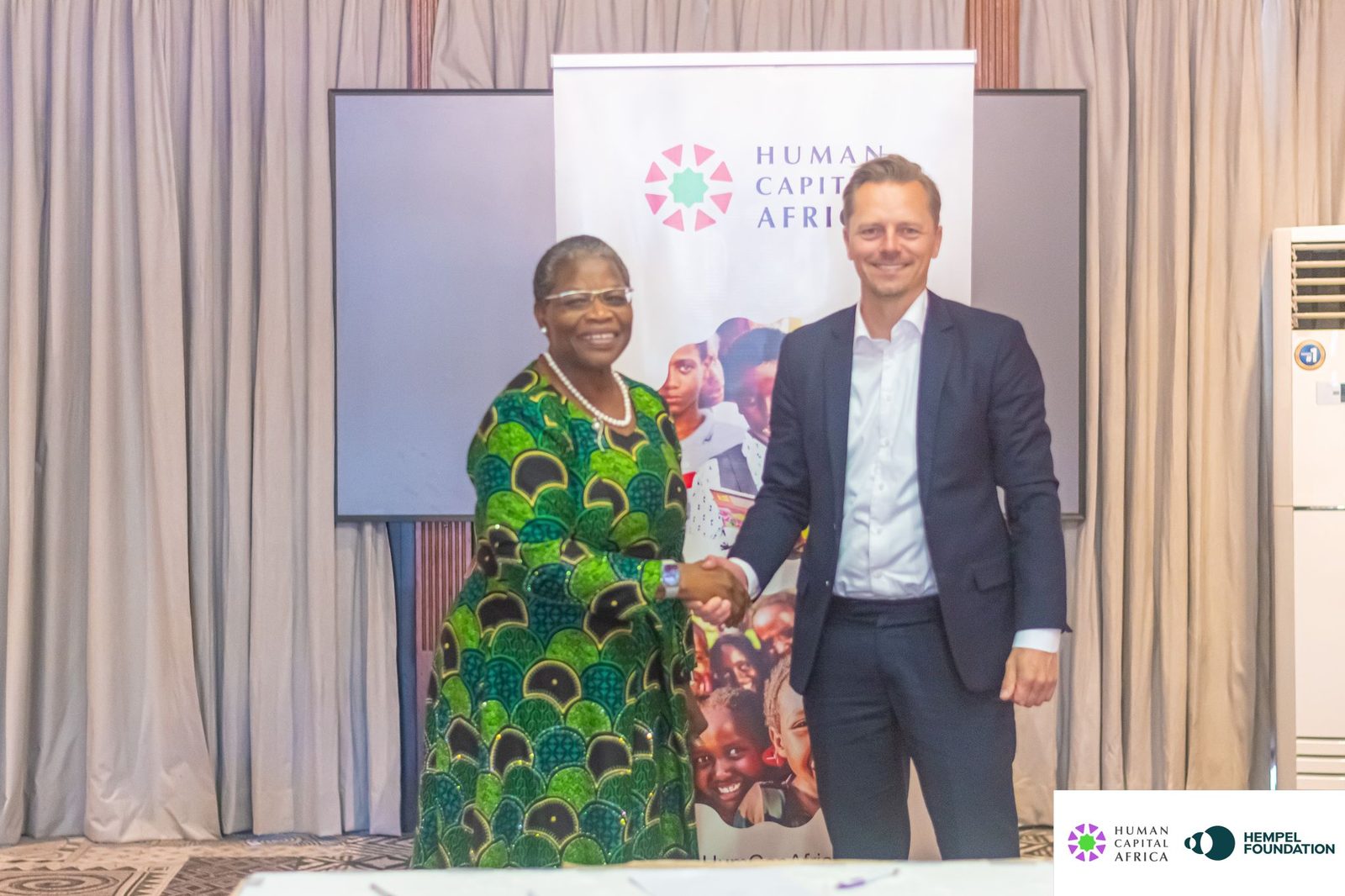 Dr Obiageli “Oby” Ezekwesili shakes hands with a Hempel Foundation representative after signing the partnership